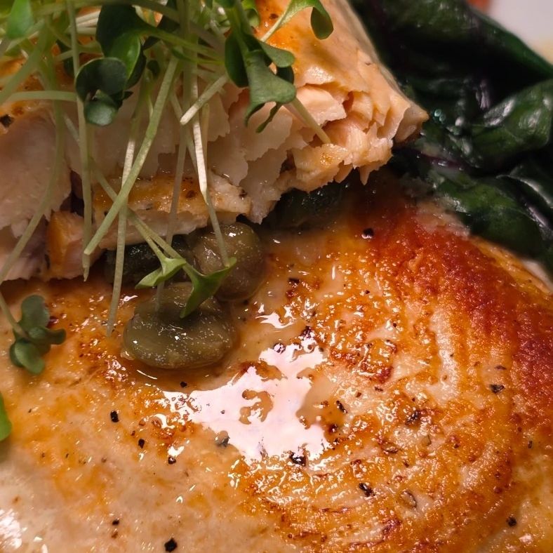 Crisp-skinned fish over purée with charred peppers