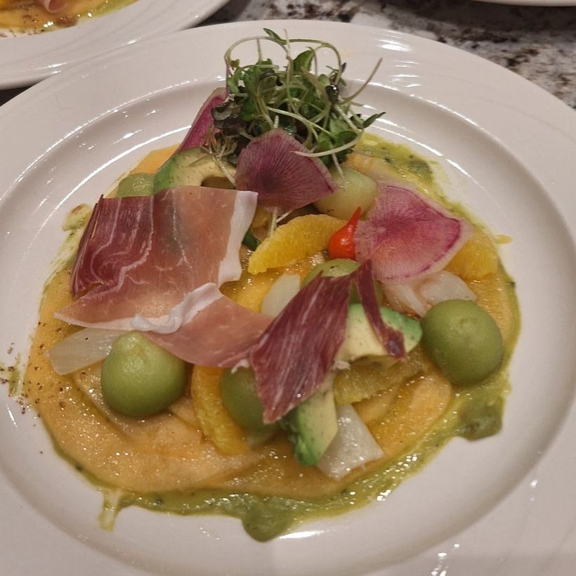 Cured ham, citrus and olives over a smooth purée